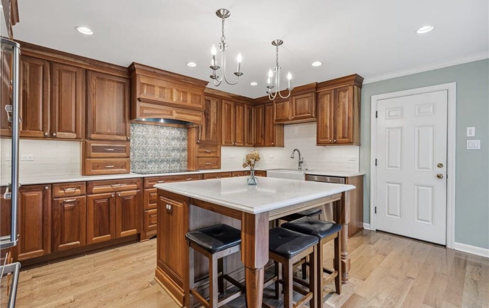 Before: honey-oak cabinets with a tiled backsplash