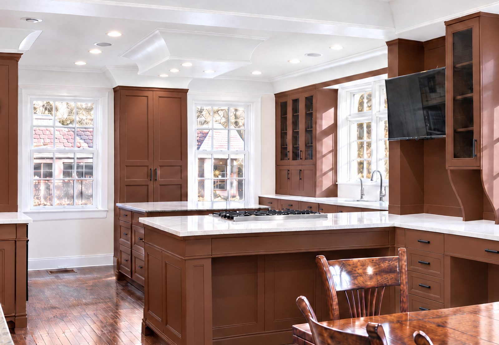 After: the same kitchen refinished in a warm terracotta with crisp white ceilings and black hardware