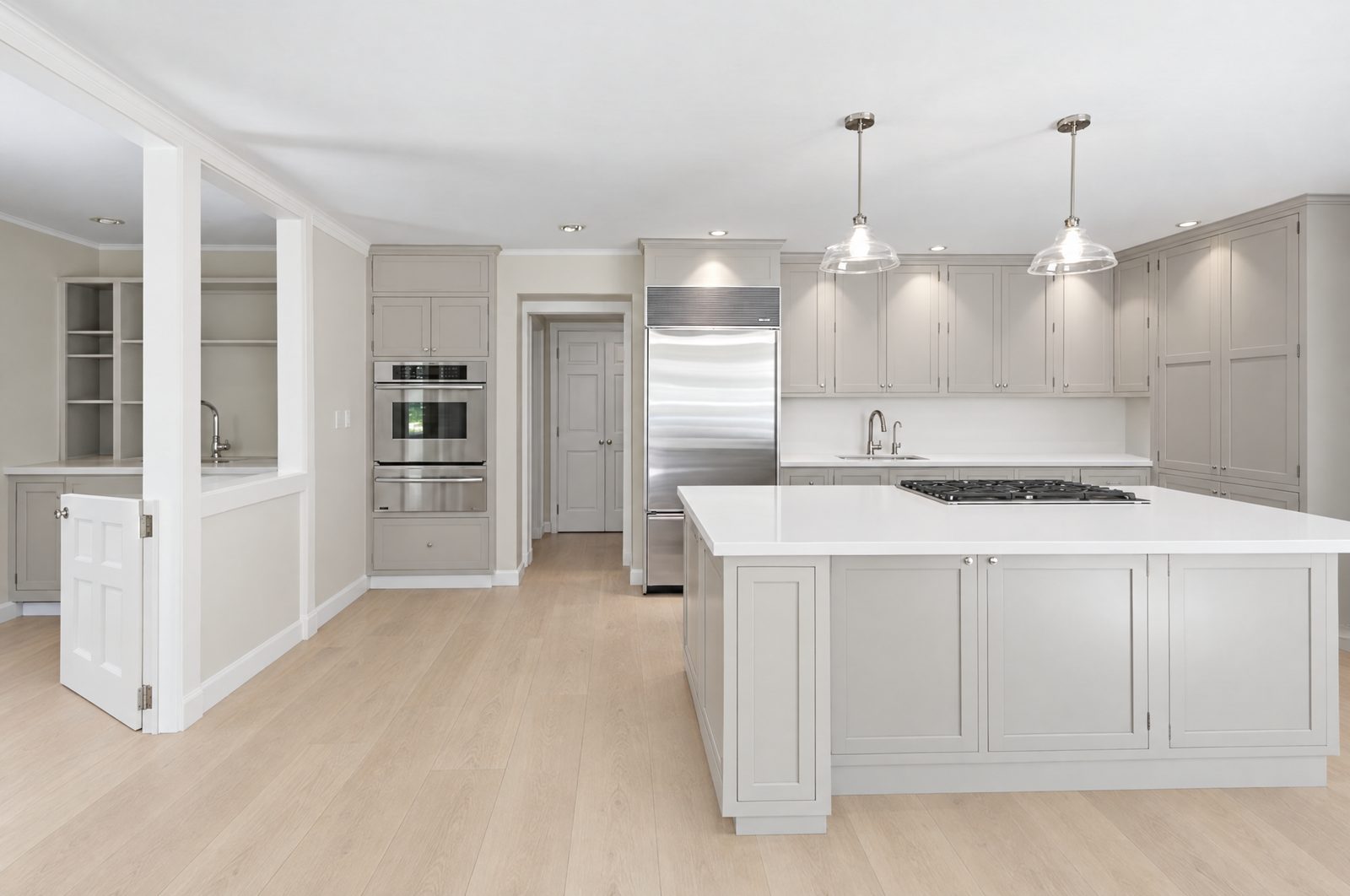 Before: flat light-grey cabinets with a white island