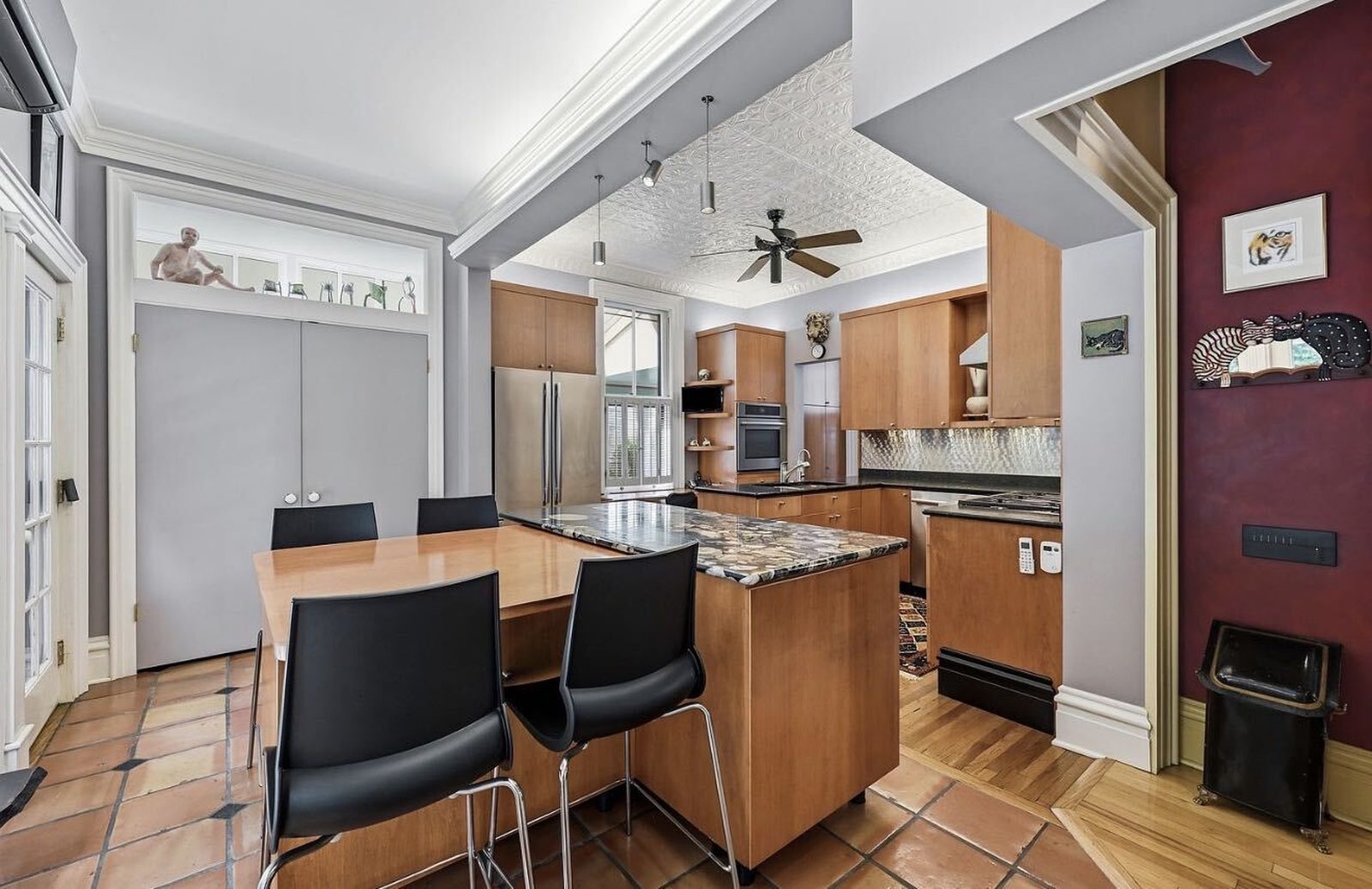 Before: maple cabinets with a dark island and burgundy accent wall