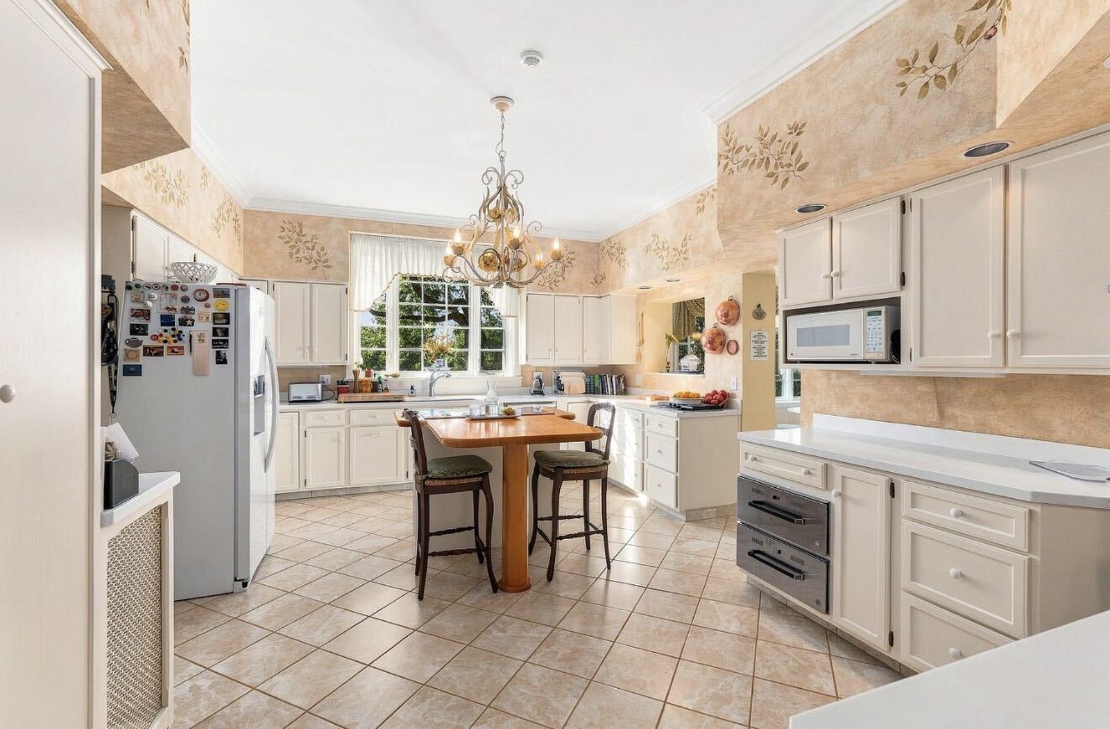 Before: white cabinets with stenciled wallpaper above